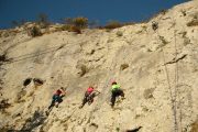 Children try rock climbing on a summer adventure holiday