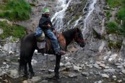 Waterfall and horse rider on a Pyrenees riding holiday