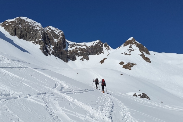 Heading up high for a fun descent Ski touring uphill