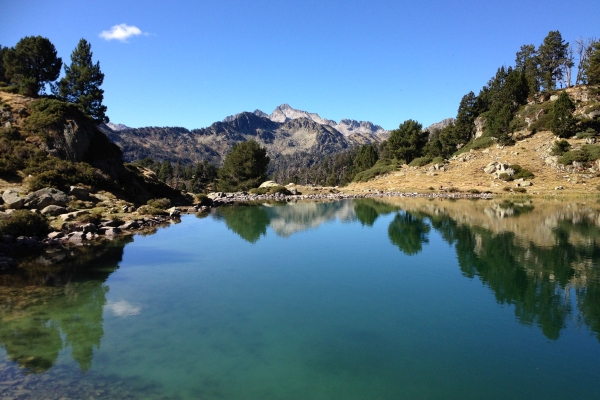 Reflections in a Pyrenees mountain lake on an autumn hike